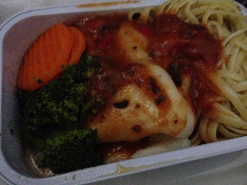 a tray of food with sauce and vegetables