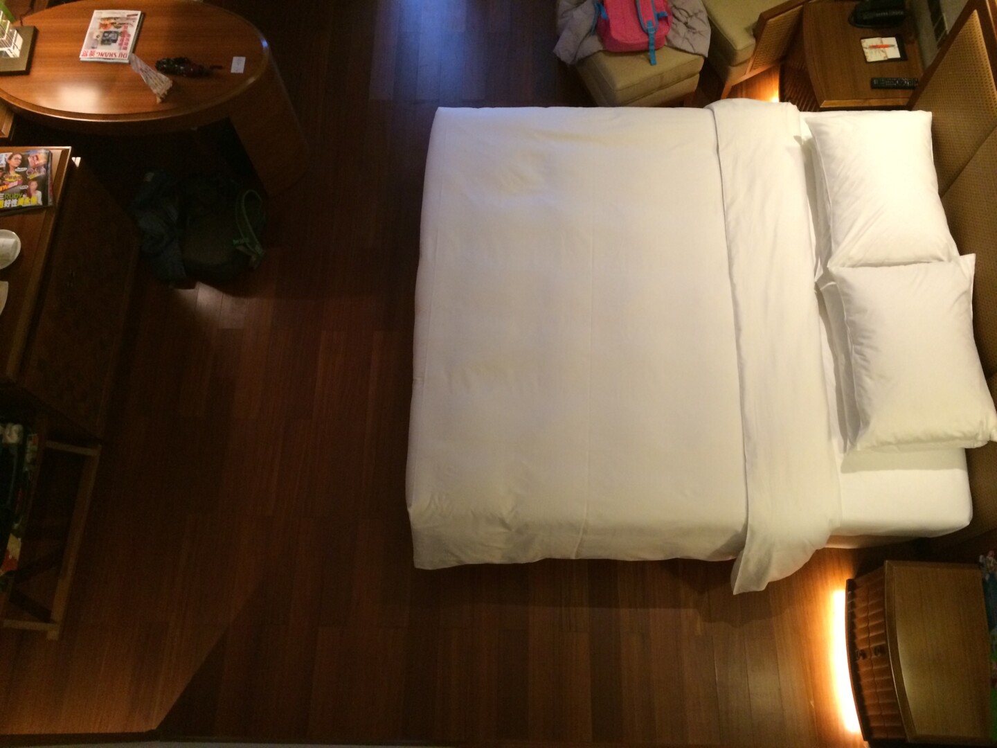 a bed with a white sheet and a table