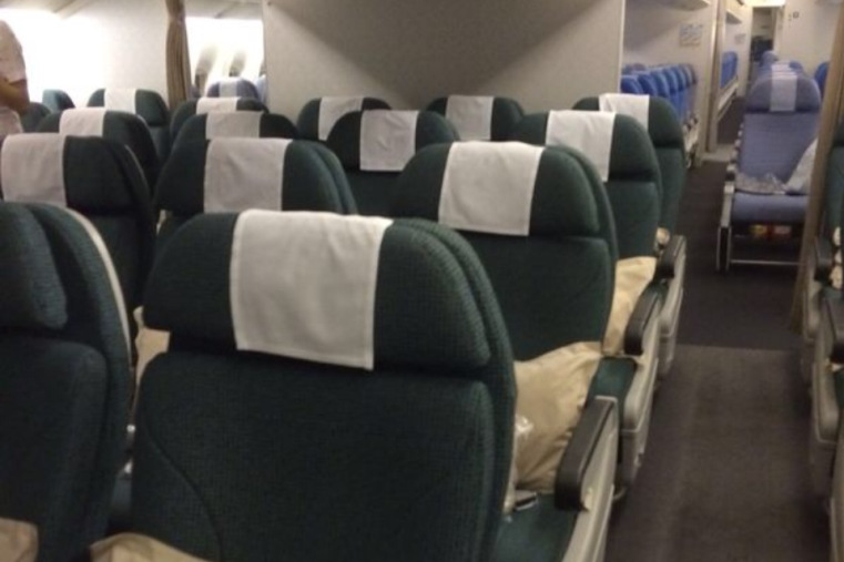 a row of seats with white cloth on them