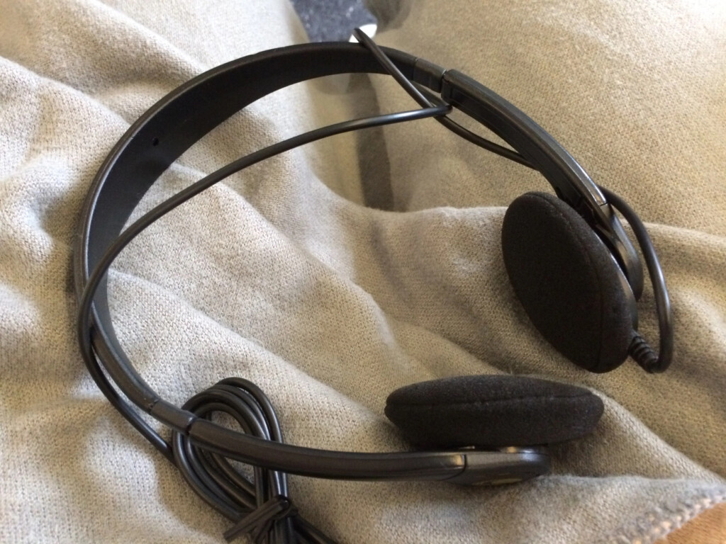 a black headphones on a white cloth