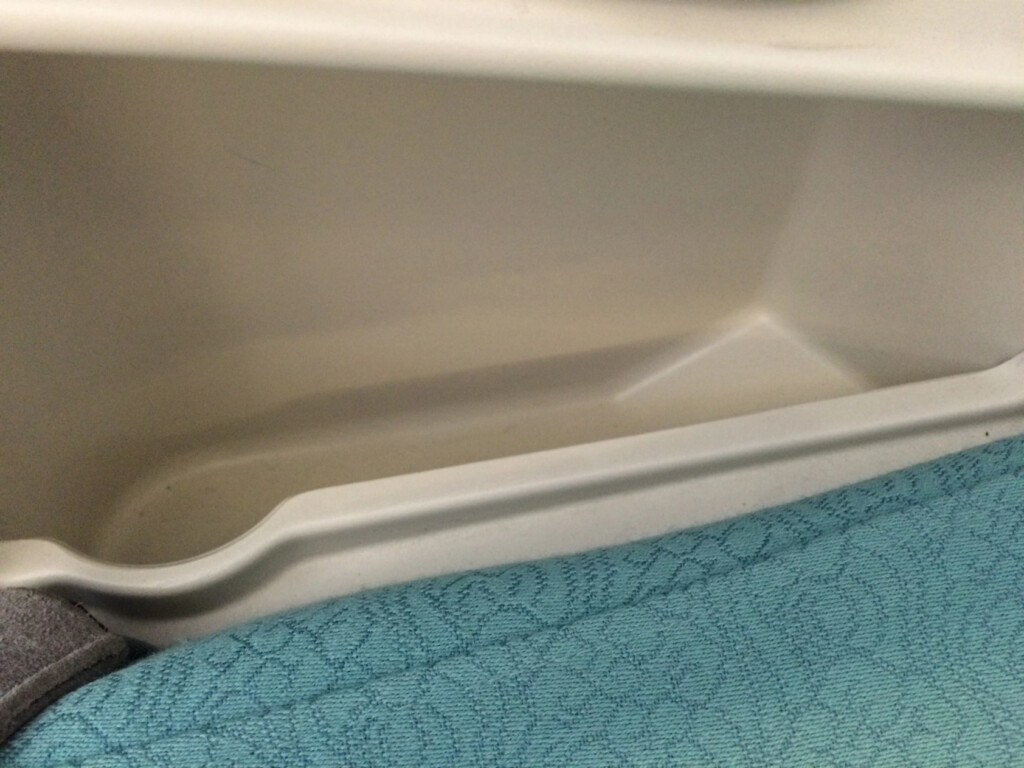 a white plastic container with a blue fabric surface