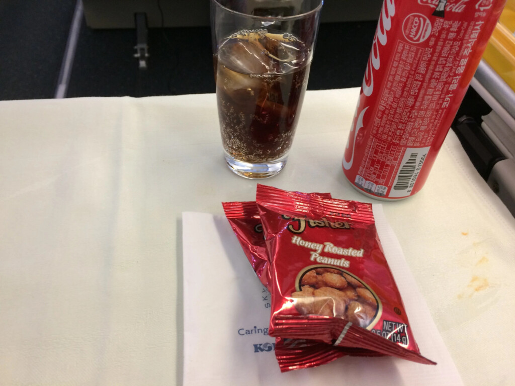 a glass of soda and candy on a table