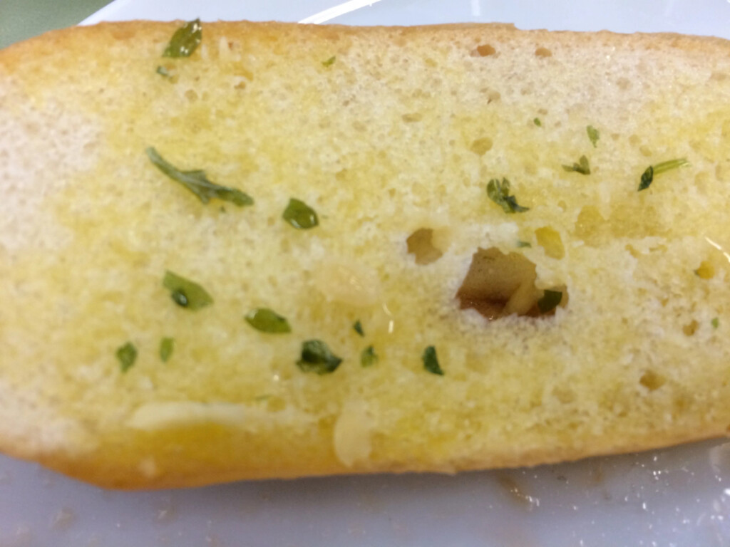 a piece of bread with green herbs on it