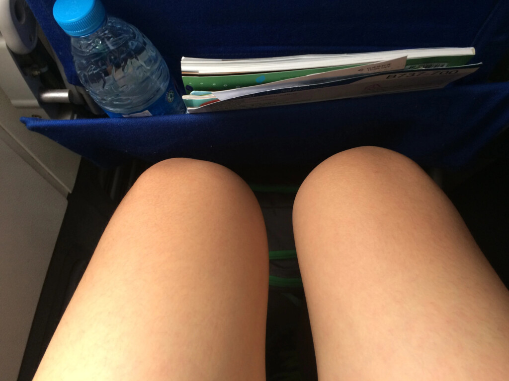 a person's legs and a bottle of water