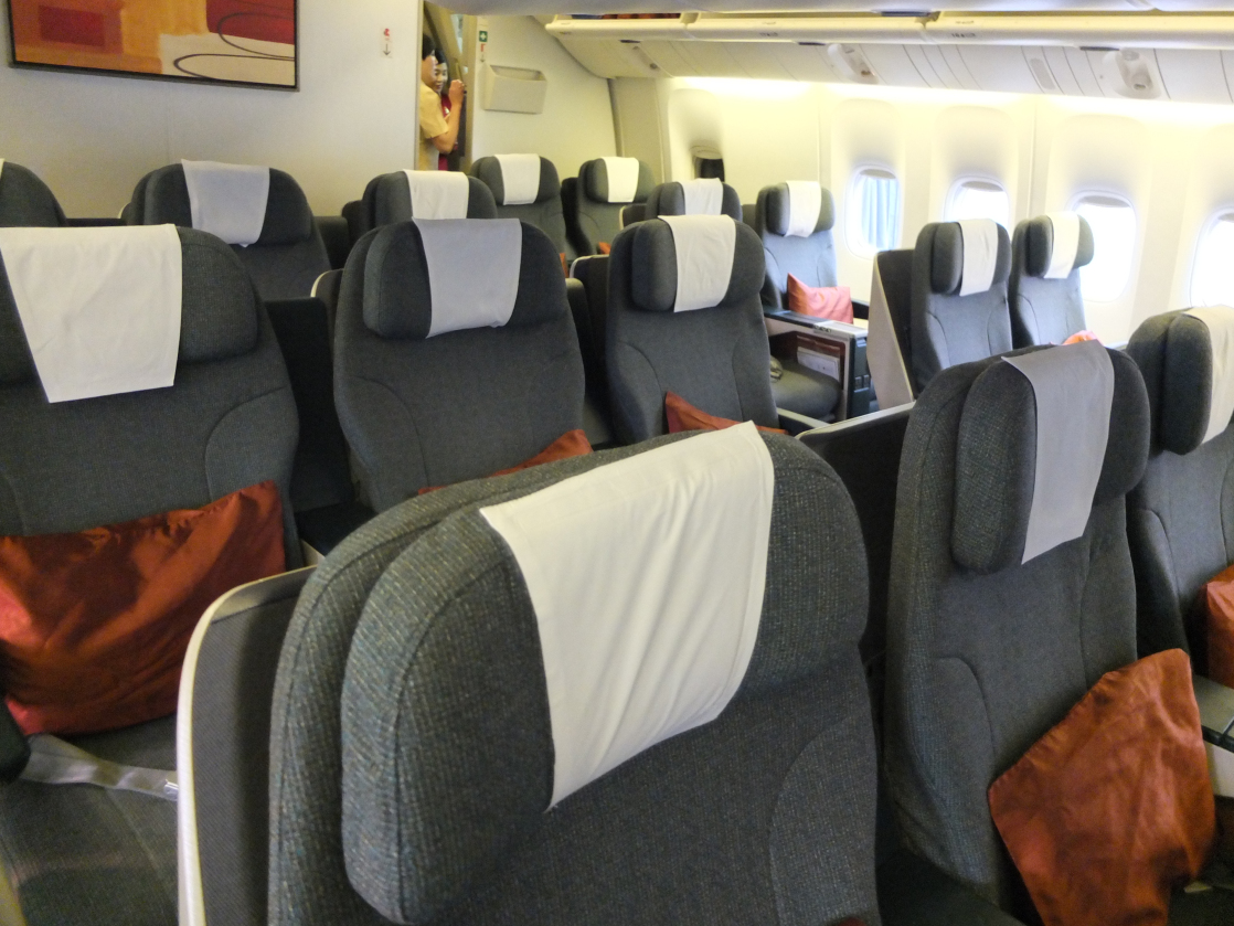 a row of grey and white seats on an airplane