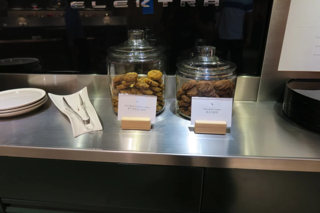 a couple of glass jars with cookies on a counter