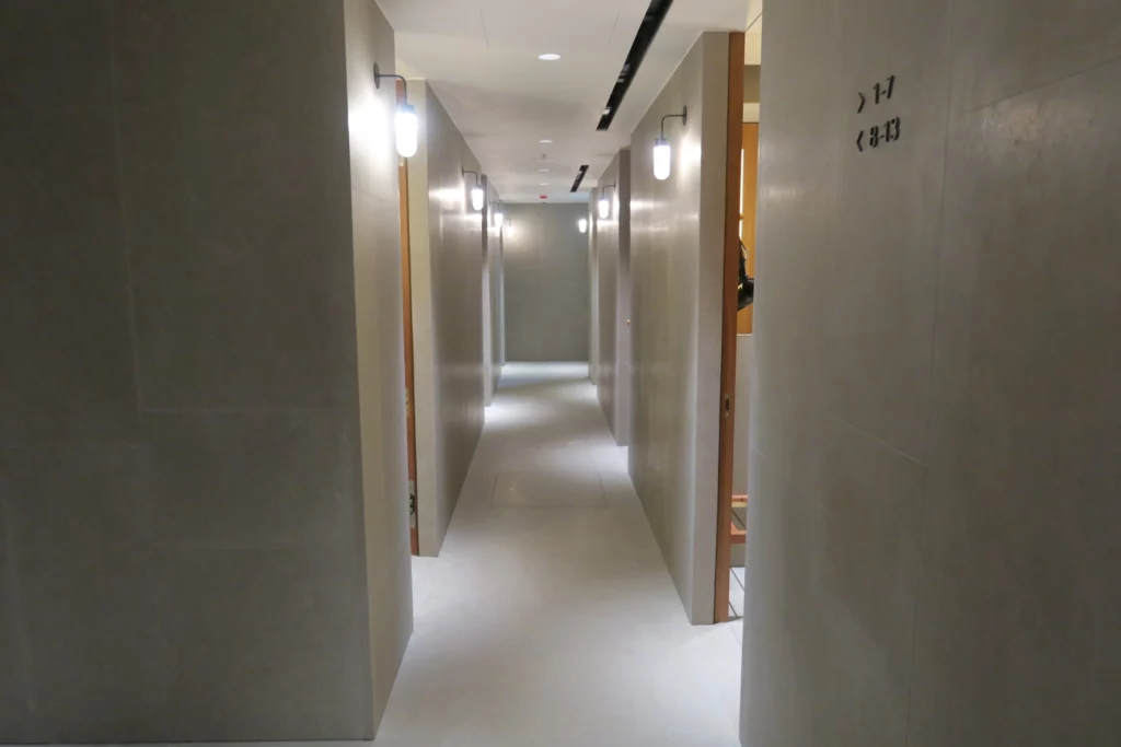 a hallway with white walls and lights