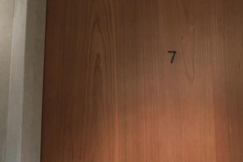 a wooden door with a number on it