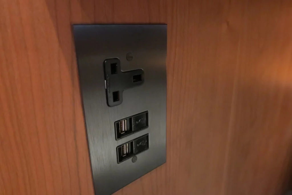 a black rectangular wall outlet with usb ports
