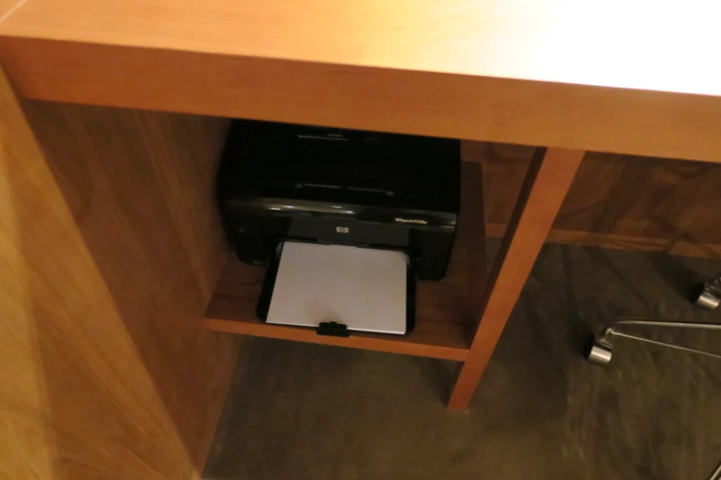 a printer in a wood shelf