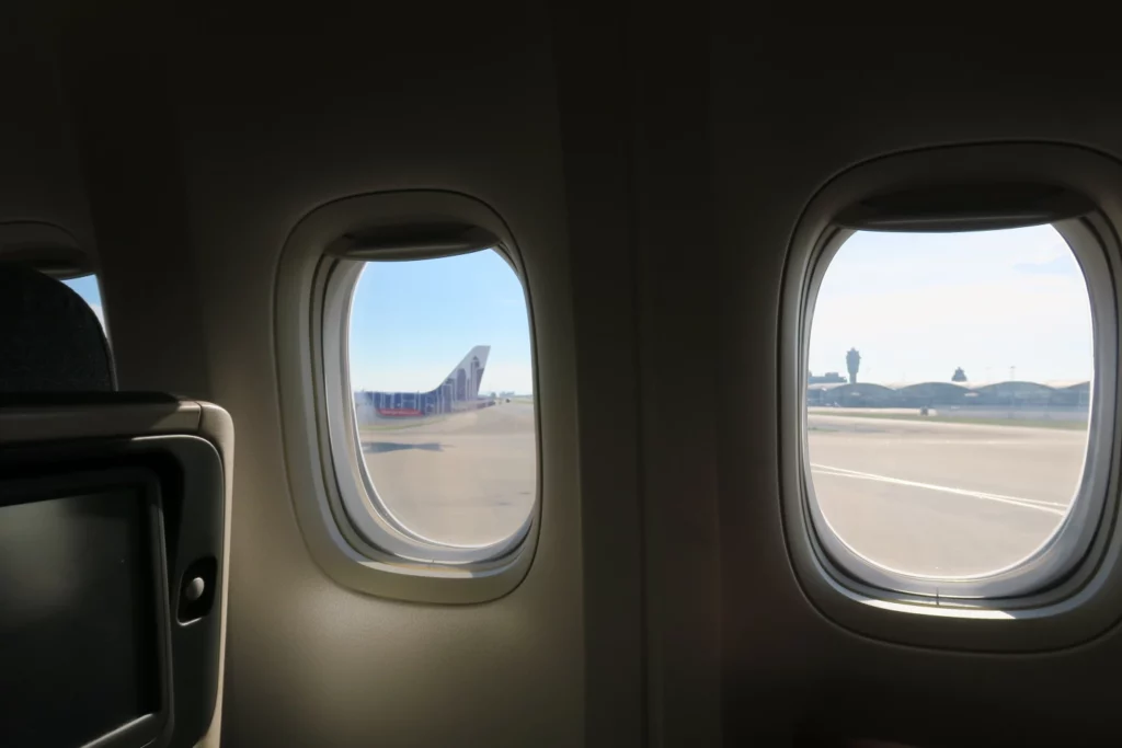 a plane with windows and a plane's wing
