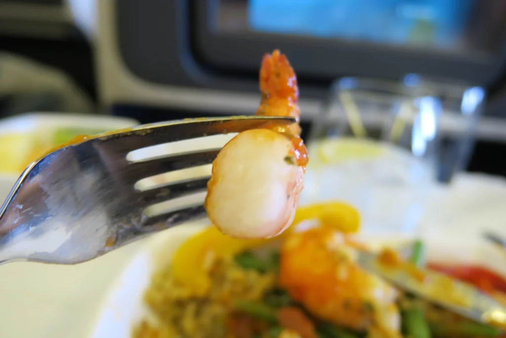 a fork with a piece of shrimp on it