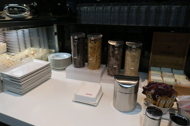 a table with different types of cereals and plates
