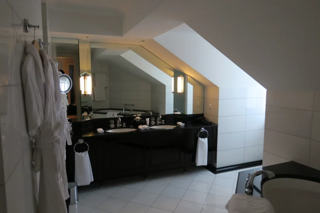 a bathroom with a large mirror and a black counter