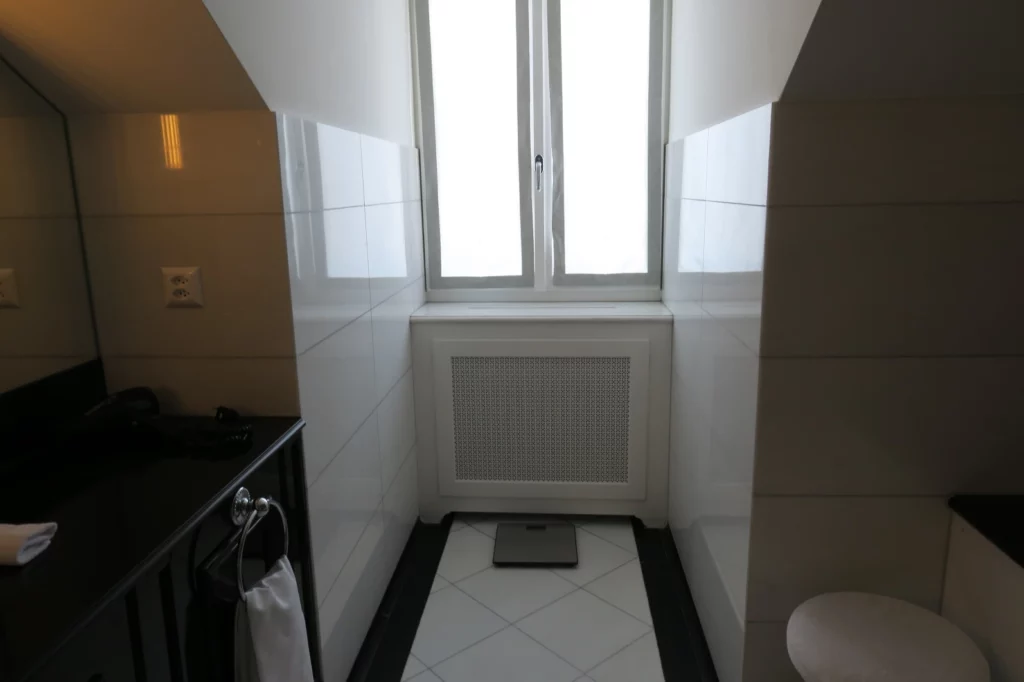 a bathroom with a window and a scale