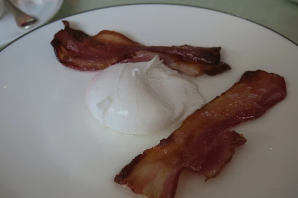 a plate of bacon and soft cheese