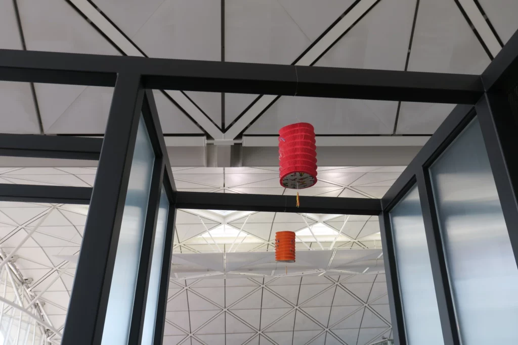 a red and orange lantern from a ceiling