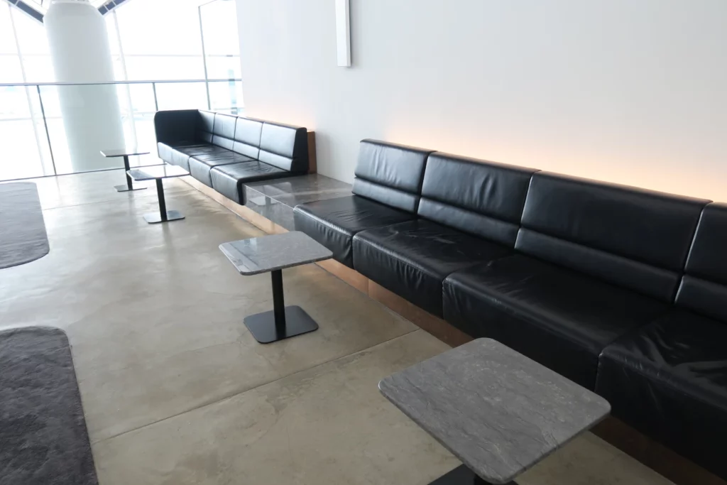 a black couches and tables in a room