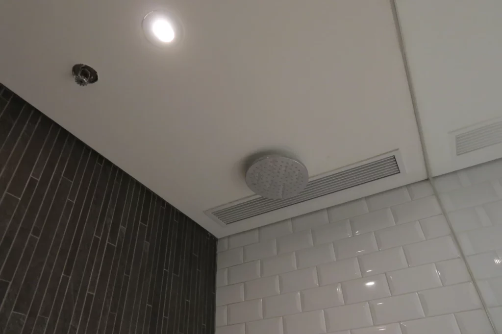 a shower head on a white ceiling