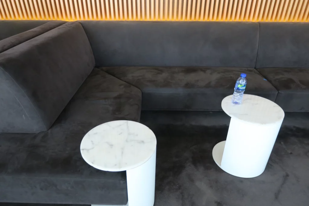 a couch with a table and a bottle of water on it