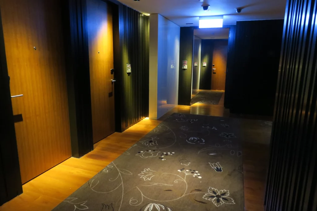 a hallway with doors and a rug