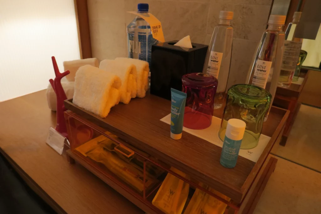 a bathroom counter with a variety of items on it