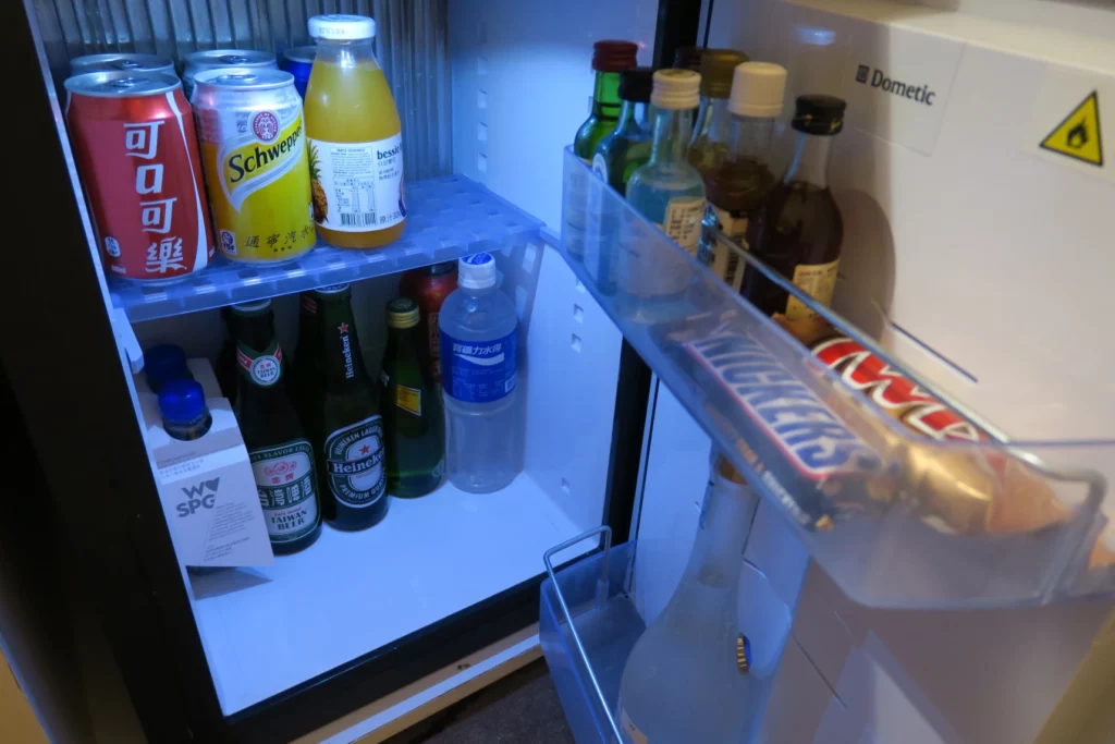 a refrigerator with drinks and candy