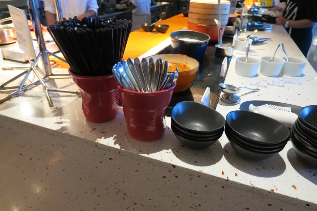 a group of utensils in cups on a counter