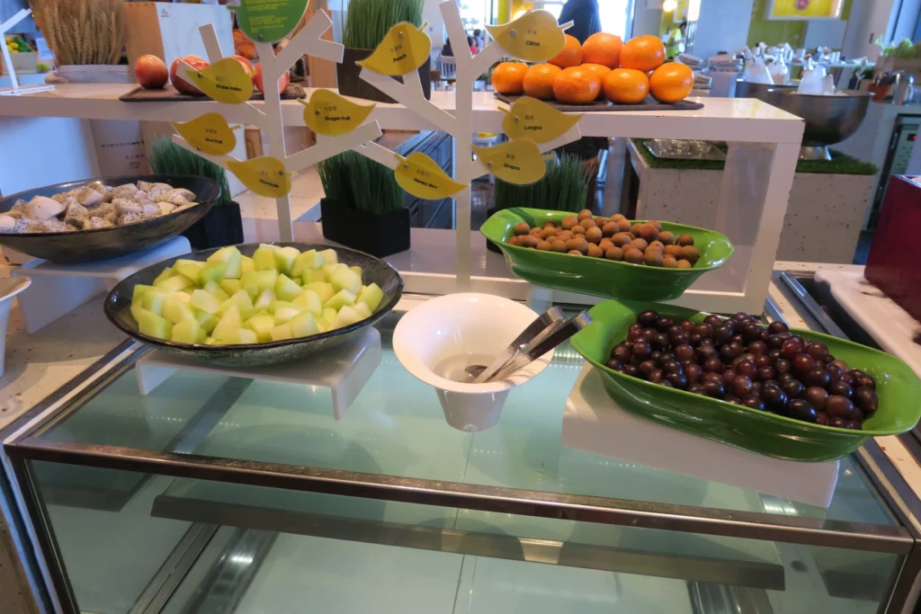 a table with bowls of fruit and a bowl of fruit