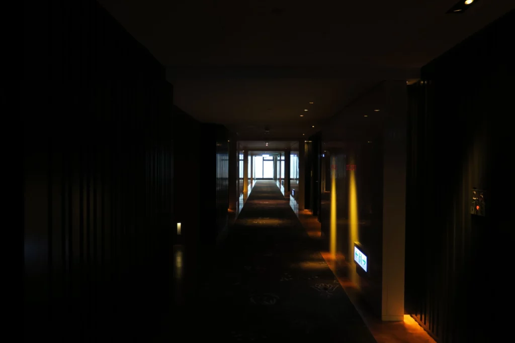a dark hallway with lights