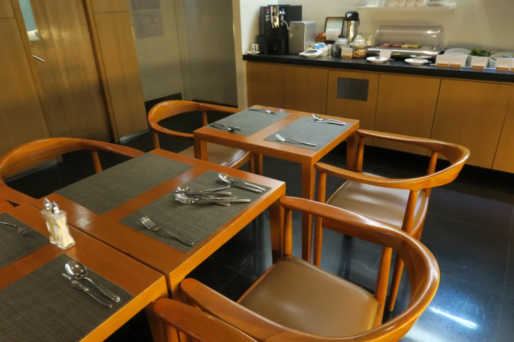 a table with chairs and silverware on it