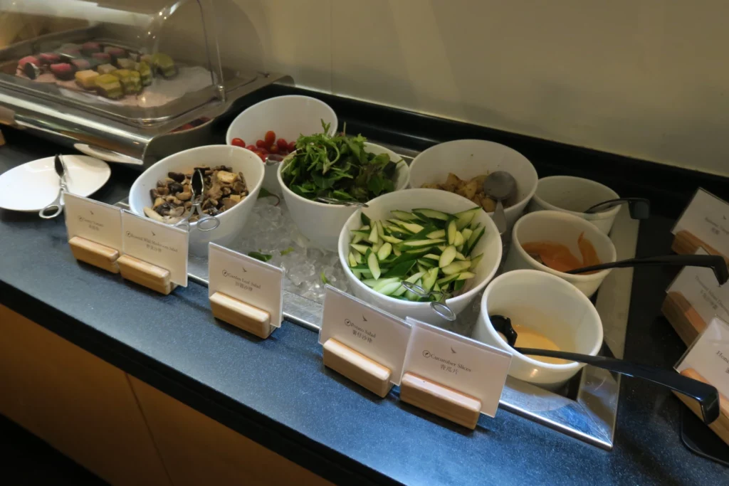 a buffet line with bowls of food