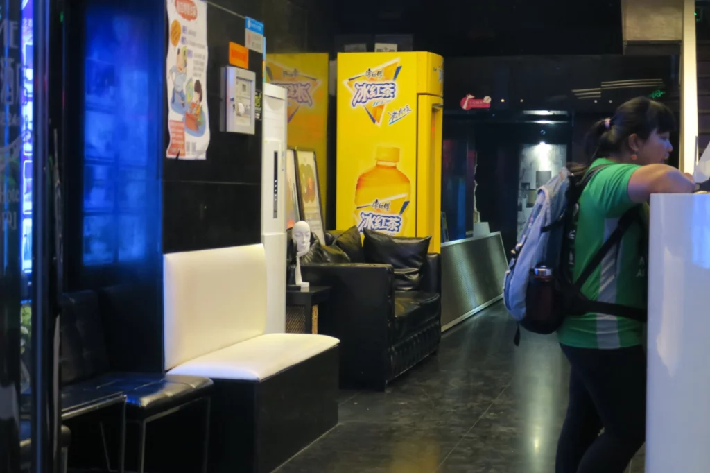 a person walking in a room with a yellow and black booth