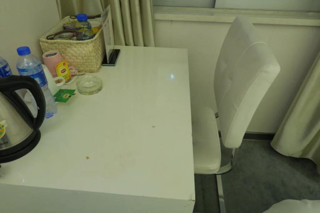 a white table with a basket of food and a chair