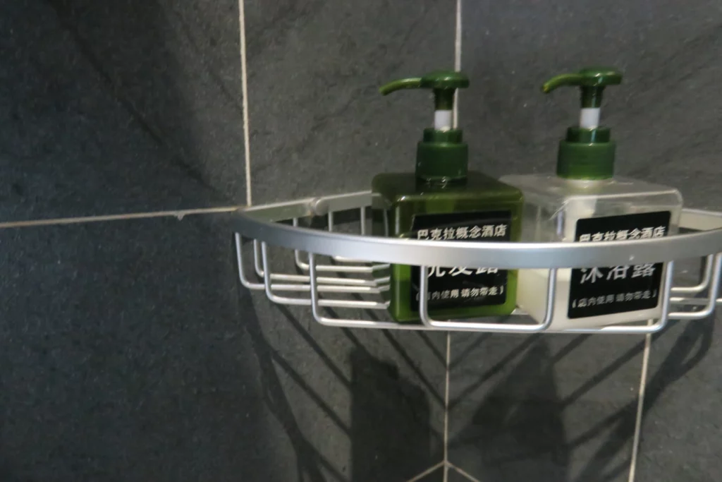 a group of soap dispensers on a shower shelf