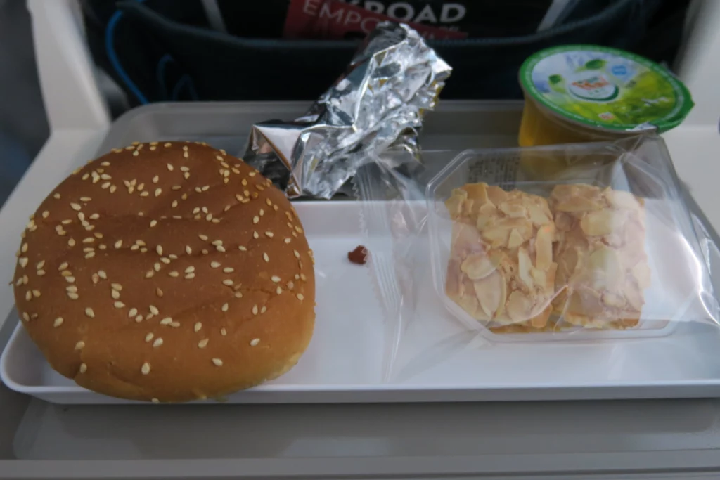 a burger and cookies on a tray