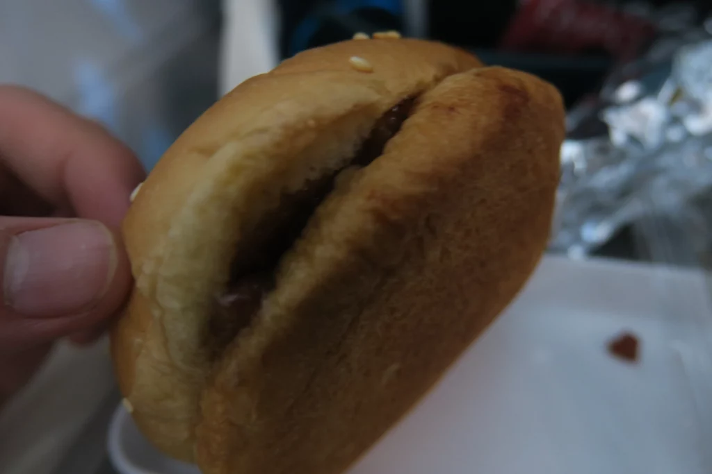 a hamburger bun with a bite taken out of it