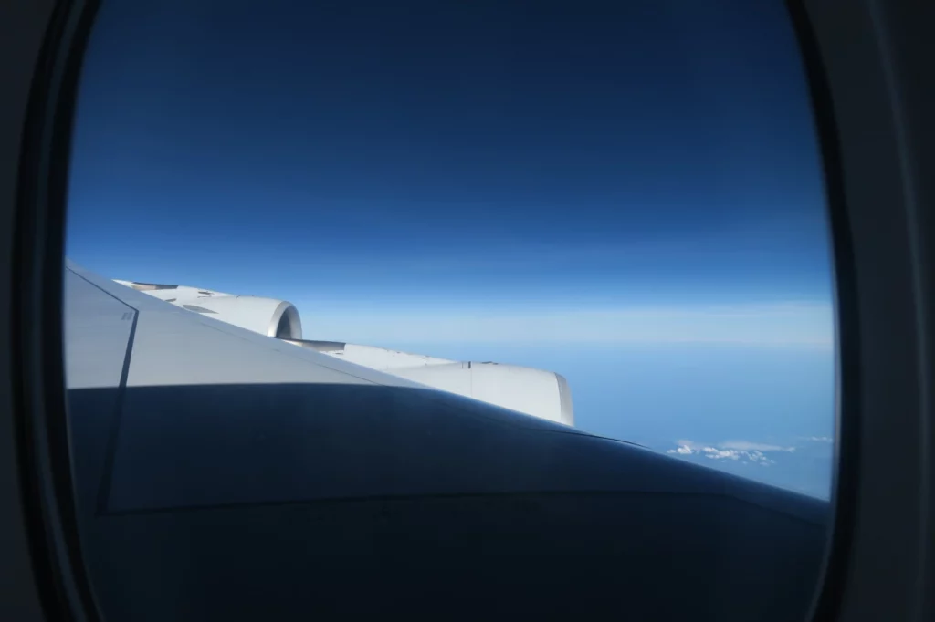 an airplane wing and blue sky