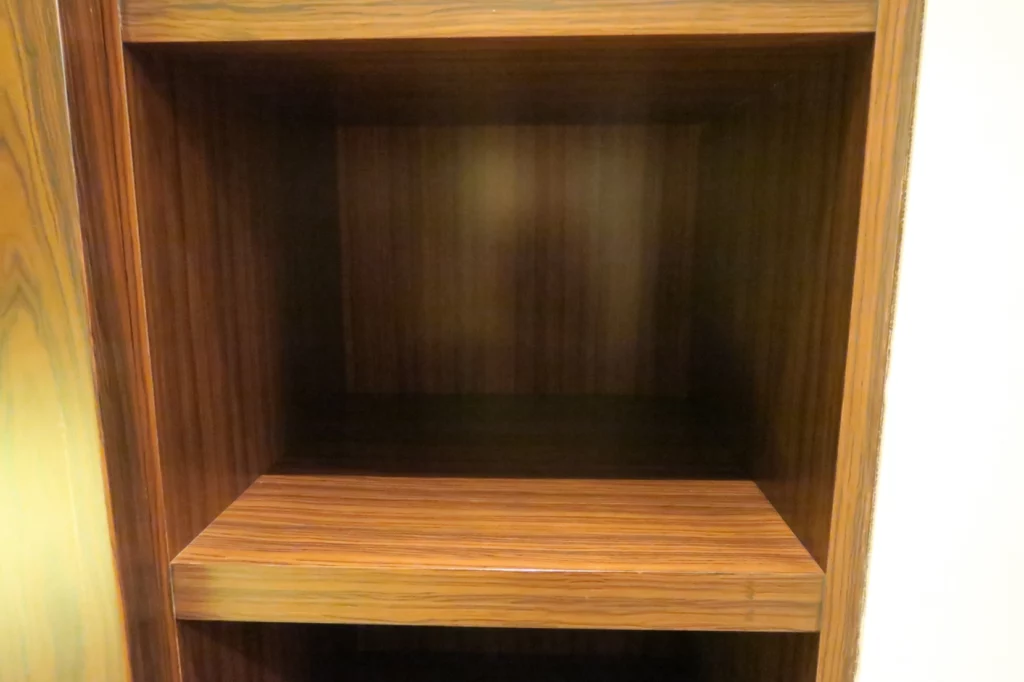 a wood shelf with a light on the inside