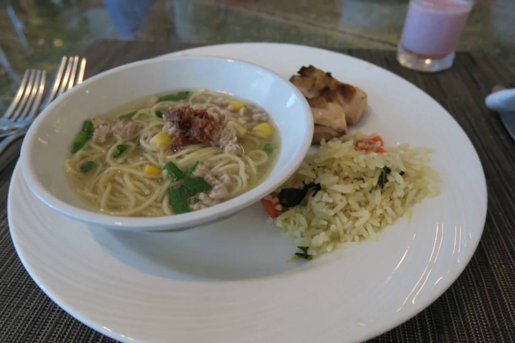 a plate of food with a bowl of soup and rice