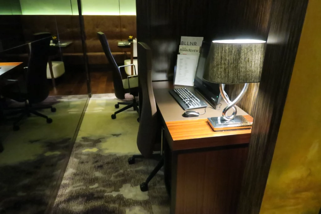 a desk with a computer and a lamp