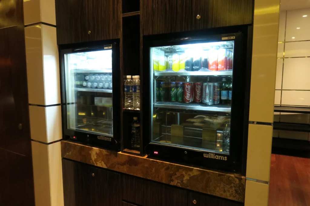 a two refrigerators with drinks in it