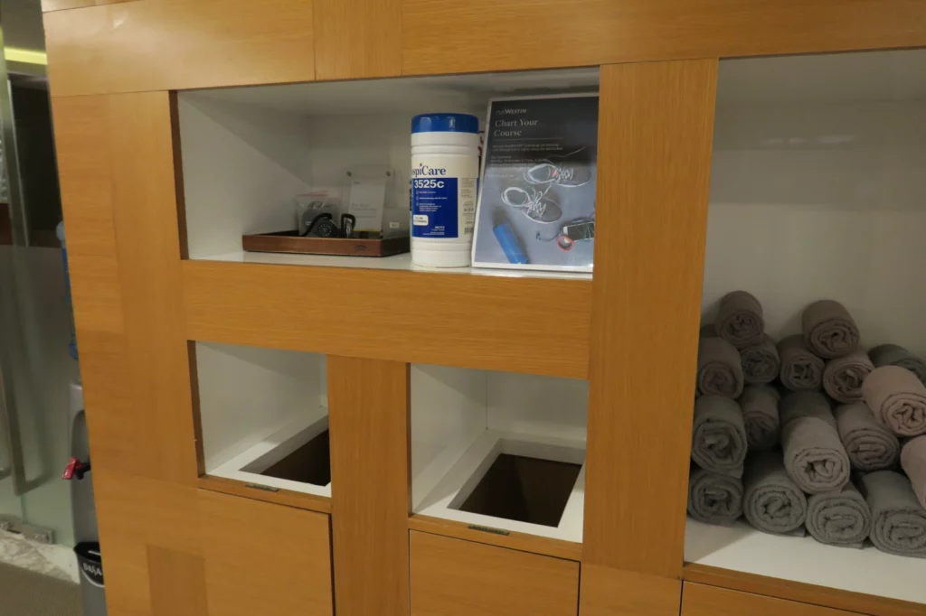 a shelf with towels and a medicine bottle