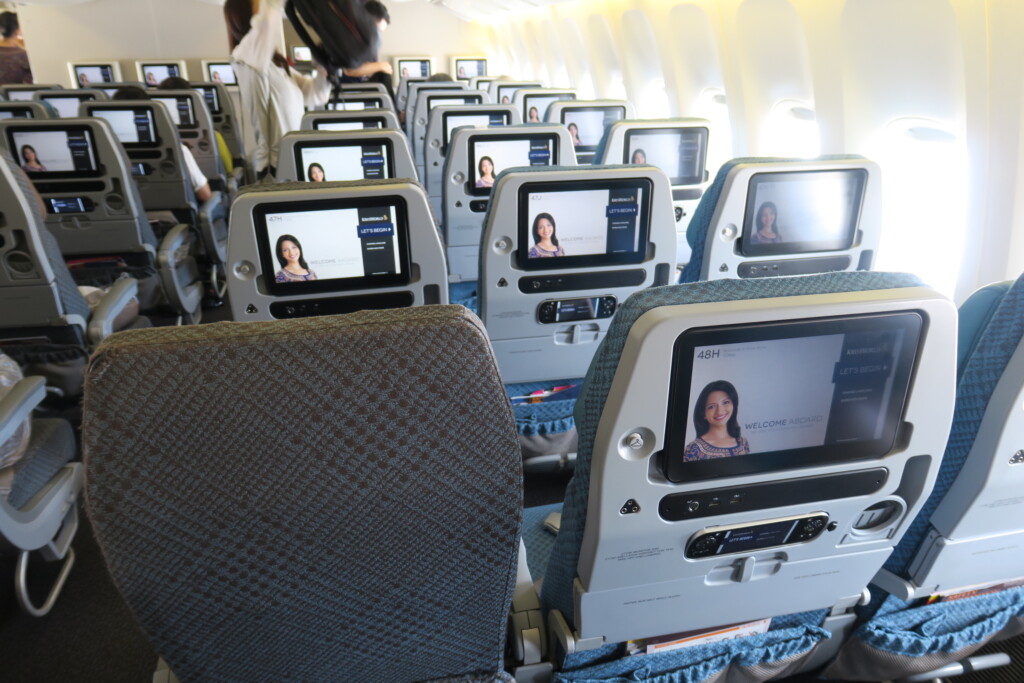 a row of seats with screens on the back