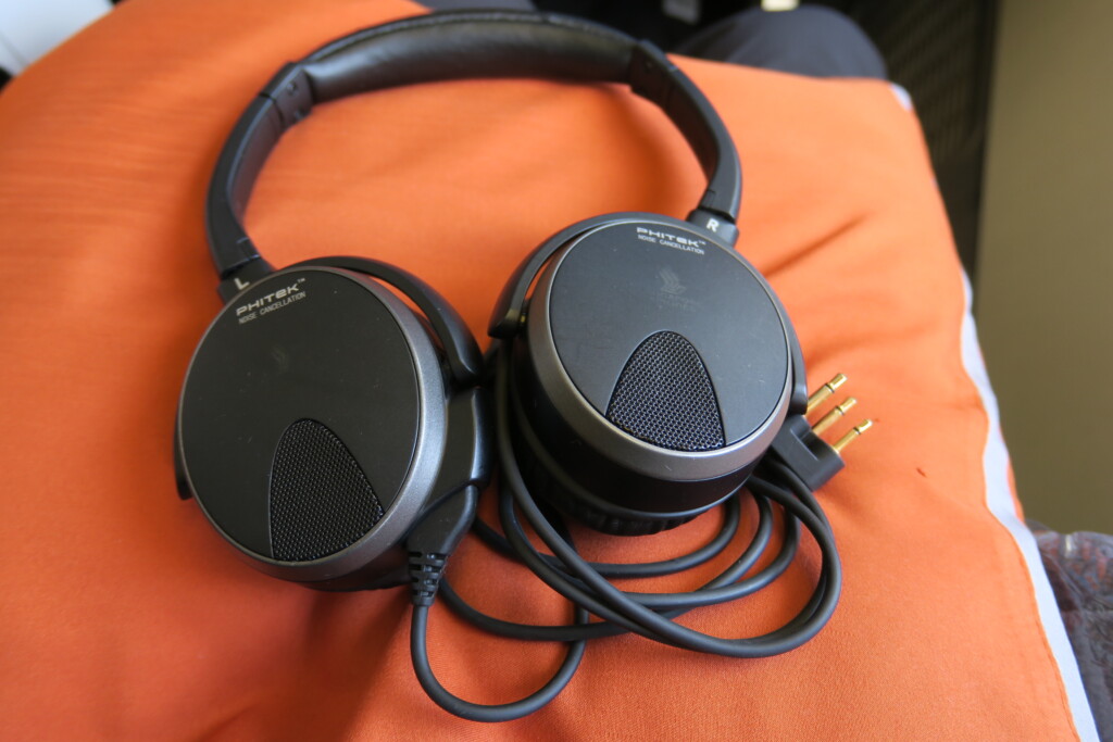 a pair of headphones on an orange surface