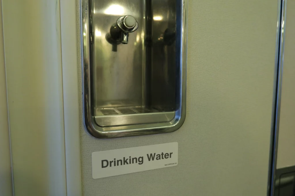 a water fountain with a sign