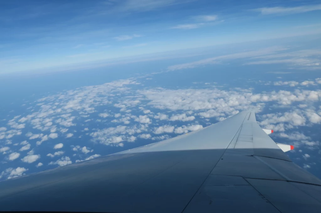 an airplane wing above the clouds