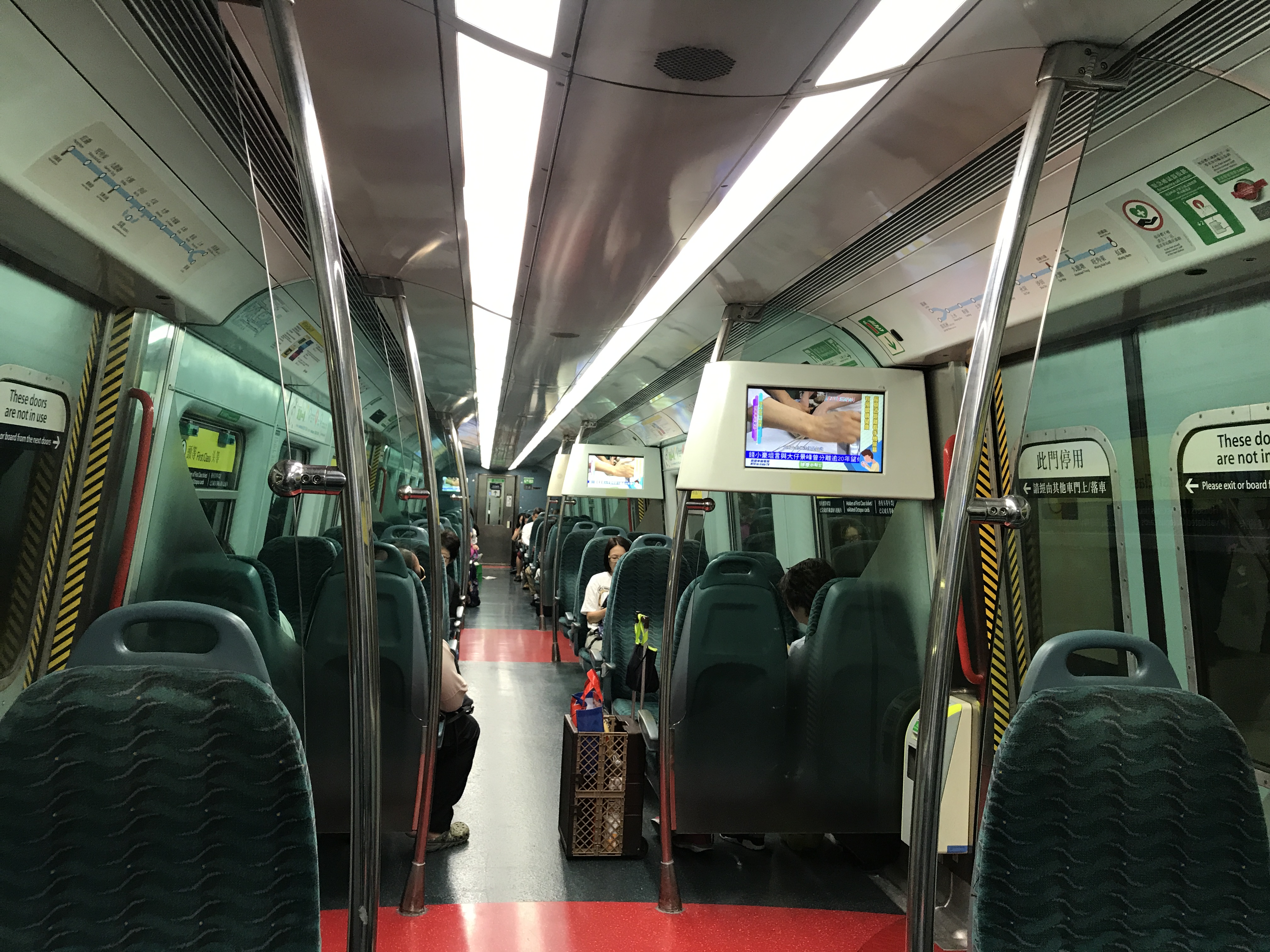 inside a train with seats and a television
