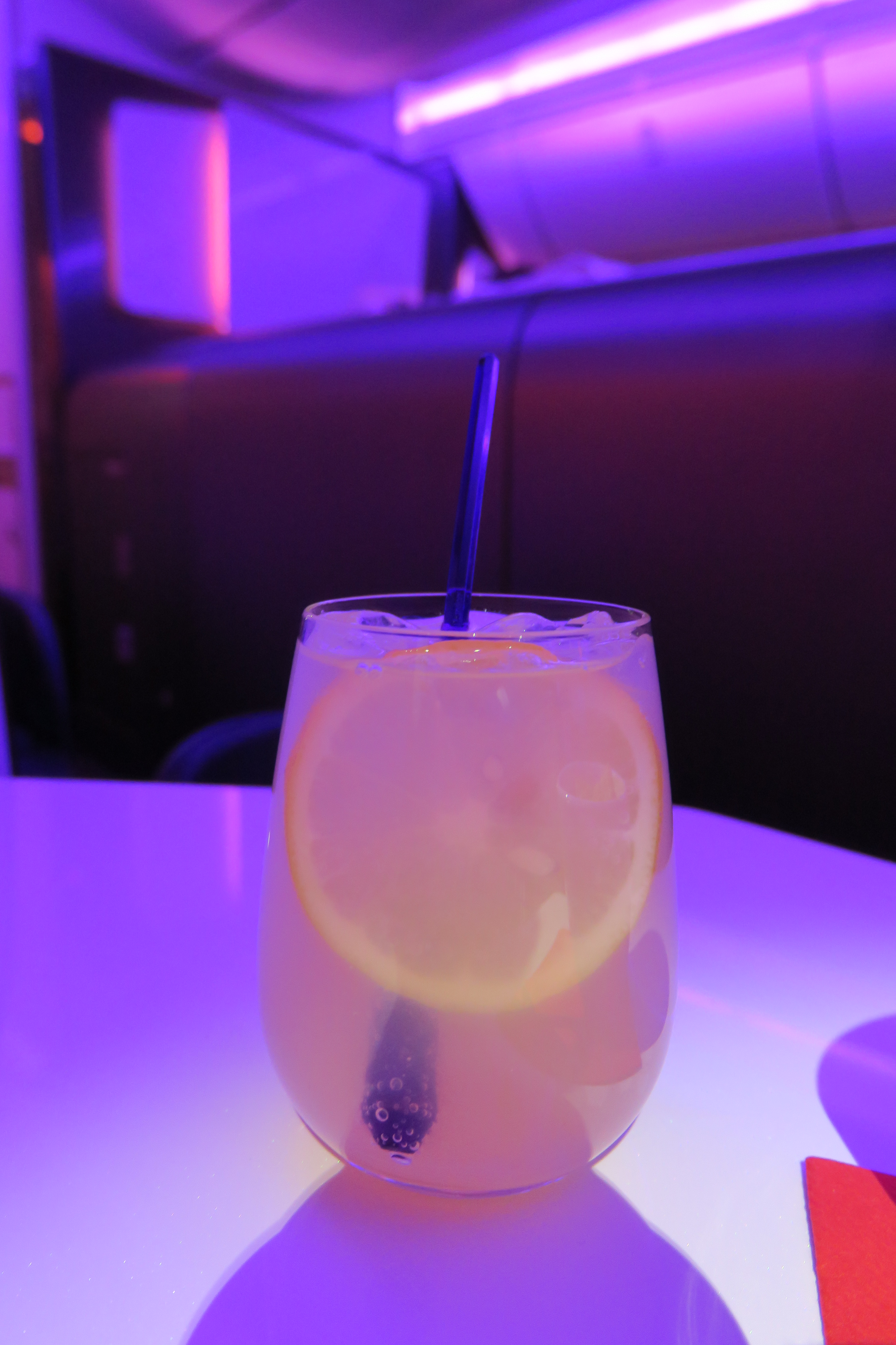 a glass with a straw and a lemon in it