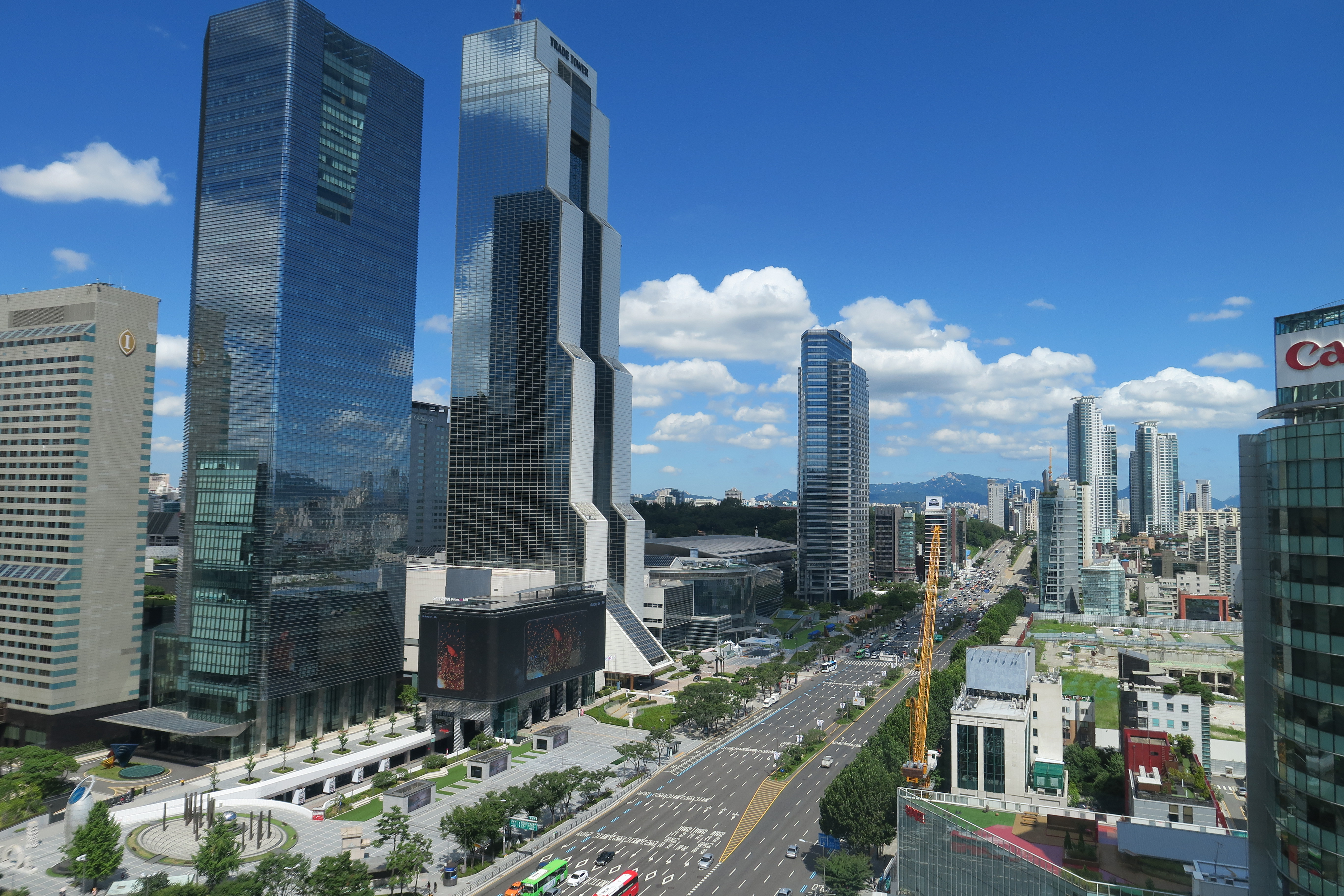 a city with tall buildings and a road